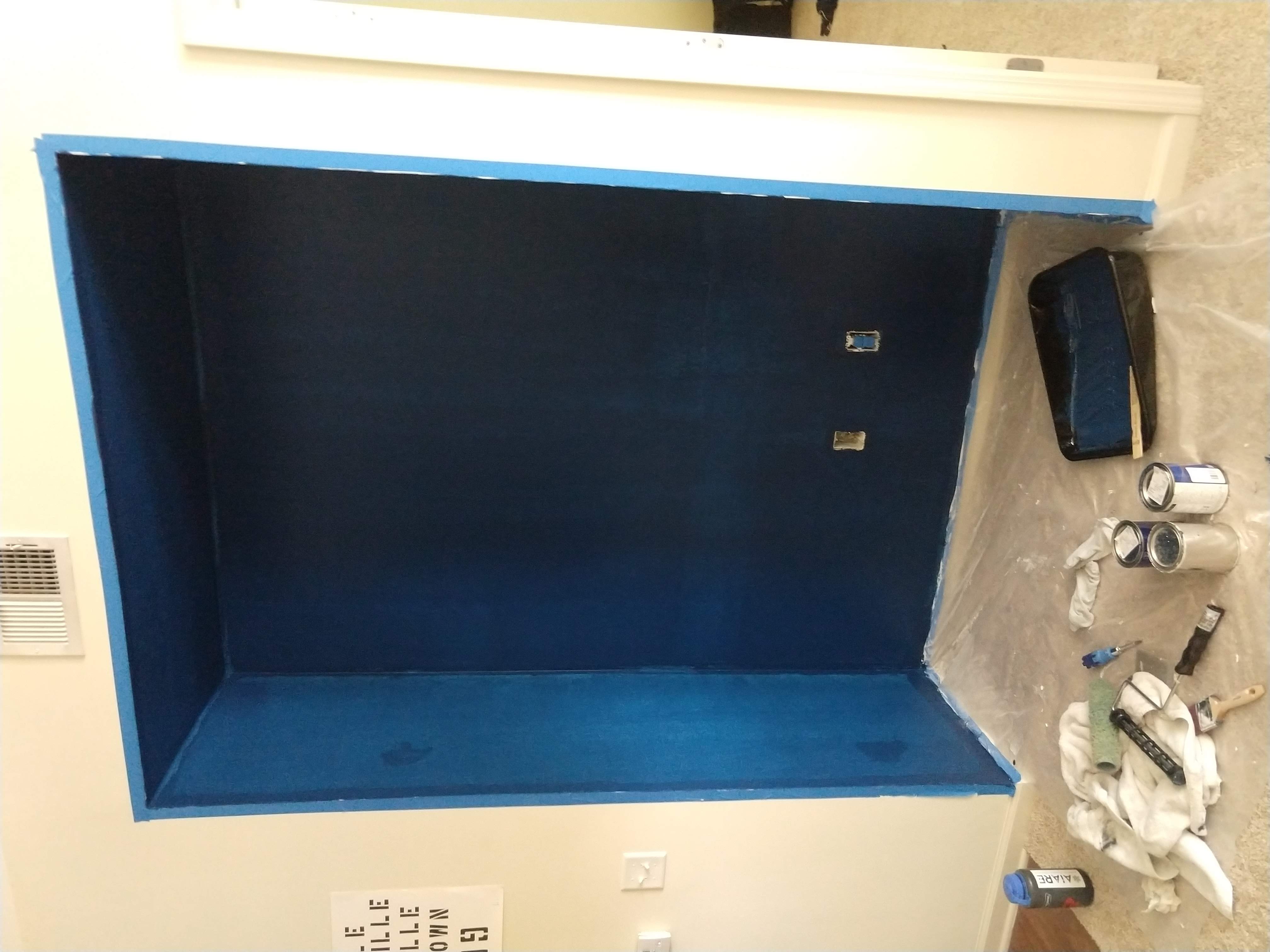 Photo of the nook now painted a mottled blue color, clearly still needing some additional coats.